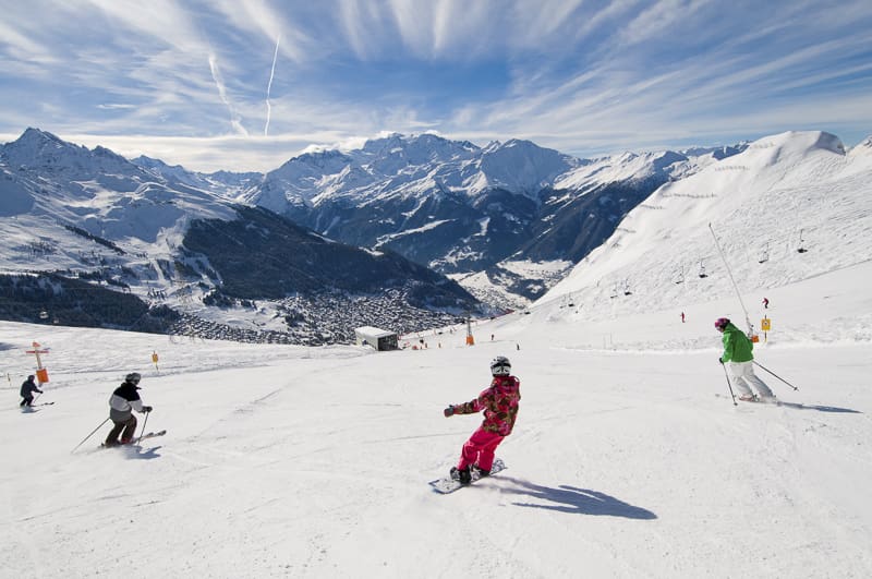 family skiing in verbier swiss alps
