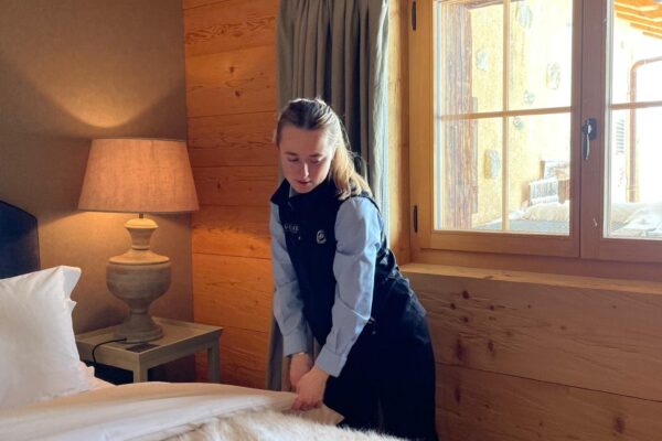 a chalet host doing housekeeping in a swiss chalet
