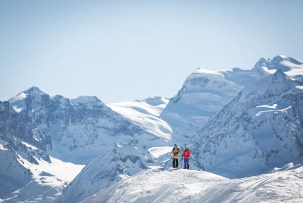 skiers with verbier mountain backdrop
